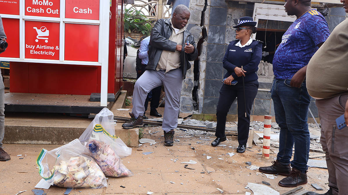 Assistant Commissioner Clement Sihlongonyane with Deputy Police Information and Communications Officer Nosipho Mnguni and other officers near vthe bombed ATM.